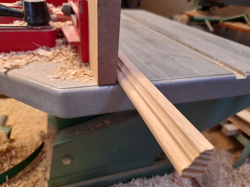Usinage de moulure en bois massif à la toupie, travail de précision artisanale en atelier